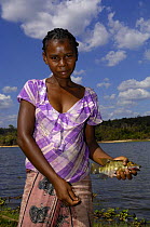 Woman fishing in Lake Ravelobe across from the Ampijeroa Forest Station. Ankarafantsika Nature Reserve, Western deciduous forest. MADAGASCAR   2005