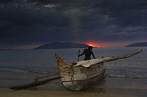 Fisherman returns from night fishing in Piroque or outrigger canoe, Ampasendava Village. North eastern MADAGASCAR 2005