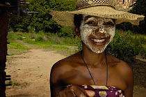 Local woman with sandalwood face mask - used as sun protection and a beautification. Isalo National Park, MADAGASCAR   2005