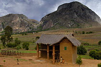 Local brick and thatched house belonging to people of the Bara tribe, with granite rocks in the background. Near Andringitra mountains, MADAGASCAR   2005
