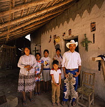 Family with Ocelot pelt, nr Rio Cuchujaqui, Sierra Madre, Mexico