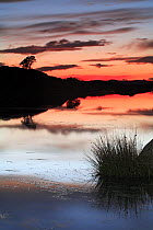 Sunset and reflection in water, Los Barruecos NP, Cáceres, Extremadura, Spain