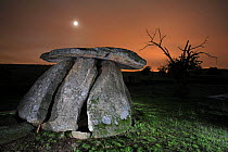 Dolmen (megalithic tomb) at night with moon, Cáceres, Extremadura, Spain