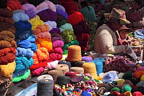 Indian woman and girl selling variety of wool colours, Chinchero, Sacred Valley, Peru 2006.