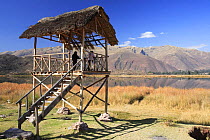 People in viewing hut, Huacarpay lake, Vilcanota Mountain range, Peru 2006.