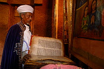 Orthodox priest reading from a Holy book, Beita Gabrielle church, Lalibela, Ethiopia, 2006