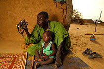 Old chief of the Fulani community with his grandchild, South Mauritania, West Africa, 2005