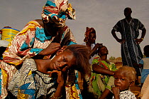 Fulani women braiding their hair, North Senegal, West Africa, 2005
