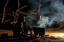 Fulani children cooking at night while their parents are busy with the cattle, North Senegal, West Africa, 2005