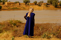 Fulani man looking across the Senegal river to his old village, Ari Funda, on the other side, South Mauritania, West Africa, 2005