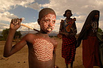Young Erbore boy shows his body paints, these are usually only applied for special celebrations, Omo valley, Ethiopia, 2006
