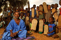 Fulani Marabout teaching the koran to children, pupils hold their wooden board on which they have written verses, South Mauritania, West Africa, 2005