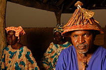 Fulani village chief wearing traditional hat, with his two wives behind, Mauritania, West Africa, 2005