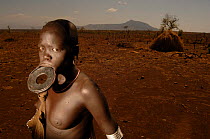 Mursi woman with large clay plate in lower lip, showing her age, Omo valley, Ethiopia, 2006