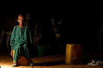 Young Fulani boy with donkeys in the background, South Mauritania, West Africa, 2005