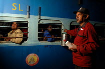 Man selling Massala chai (tea) to travellers at Bharatpur railway station, Rajasthan, India 2006