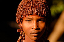 Young girl from the Turmi village with traditional hair braiding with mud and butter, and shell jewellery, Omo valley, Ethiopia, 2006