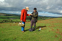 Member of the Shropshire Fungi Group looking for fungi, Hopesay Hill (National Trust) Shropshire Hills an Area of Outstanding Natural Beauty, UK 2006