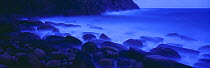 Porthcurno Twilight, waves breaking around rocks at dusk, Cornwall, England, UK