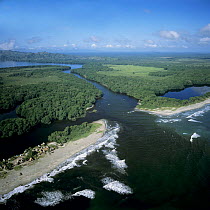 Aerial view of 'Miami' fishing village on the Caribbean coast with Laguna de los Micos (the Lost Lagoon) in the background, Honduras, Central America 2006