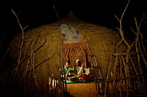 Fulani family in traditional hut sharing meal, Mauritania, West Africa, 2005