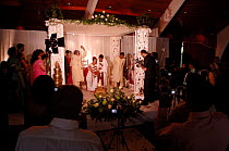 Traditional indian wedding being filmed by guests, London, UK. 2006