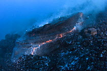 Hot molten pillow lava erupts from an underwater lava tub at ocean entry of eruption from Kilauea Volcano, Hawaii, USA