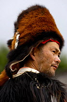 Tibetan man wearing winter hat made from Red Panda {Ailurus fulgens} skin. Lijiang, Yunnan Province, China   2006