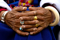 Portrait of womans hands adorned with heirloom jewellery at the Horse Racing Festival or 'Heavenly Steed Festival' which takes place on the 5th and 6th days of the fifth lunar month. Zhongdian, Deqin...