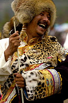 Tibetan man at the Horse Racing Festival or 'Heavenly Steed Festival' wearing endangered wild leopard cat skins, Zhongdian, Deqin Tibetan Autonymous Prefecture, Yunnan Province, China 2006