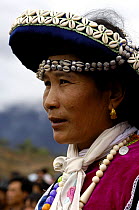 Mosuo (or Moso) woman in traditional dress at the Horse Racing Festival or 'Heavenly Steed Festival' which takes place on the 5th and 6th days of the fifth lunar month. Zhongdian, Deqin Tibetan Autony...