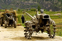 Lisu ethnic minority with modern plough for paddy field work. Zhongdian, Deqin Tibetan Autonomous Prefecture, Yunnan Province, China 2006