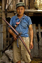 Black Lisu ethnic minority man with crossbow - used to hunt wild animals that live in the hills near Fulong, Nujiang Prefecture, Yunnan Province, China 2006