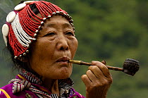Black Lisu ethnic minority woman smoking a pipe, Nujiang Prefecture, Yunnan Province, China 2006