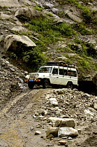 Four wheel dirve vehicle  on a narrow road / track, Nu River Canyon near Gongshan in Dulongjiang Prefecturate, Yunnan Province, China 2006
