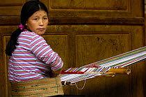 Dulong woman weaving cloth for their traditional dress, Gongshan County, Yunnan Province, China 2006