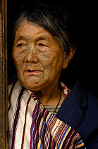 Dulong woman (Qing Nian) born in 1942 - her face was tatooed at the age of 8 - Longyuan Village in Dulong County near Gongshan, Yunnan Province, China 2006