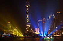 The Bund (waterfront) in Shanghai, looking across the river at the Oriental Pearl TV tower located in Pudong Park, China 2006