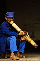 Old man smoking through a bong pipe, Yunnan Province, China 2006