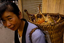 Woman carying a butchered dog for eating, Yuanyang, Honghe Prefecture, Yunnan Province, China   2006