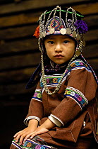 Portrait of a Hani child in traditional costume, Yuanyang, Honghe Prefecture, Yunnan Province, China 2006