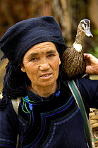 Hani woman carrying a domestic duck on her shoulder. Hani Ethnic minority people. Yuanyang, Honghe Prefecture, Yunnan Province, China 2006