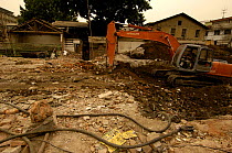 Bulldozers removing old buildings in Dashanlan Street which forms part of the 'Hutongs' or networks of alleys and traditional courtyards, most of which have been destroyed to make way for a modern Bei...