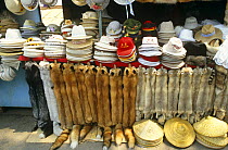 Hats and fox pelts for sale on market stall, Beijing, China