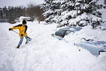 Man digging car out from snow, Ithaca, New York, USA, after 17 inch overnight snowfall, February 2007
