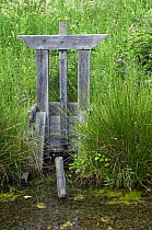 Traditional wooden sluice, called "bonde", used in fish-farming in La Brenne where the lakes are inter-connected in series, France