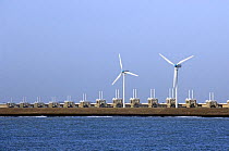 Storm flood barrier and wind turbines at Neeltje Jans, part of the Delta Works that regulates the enormous tidal flows and harnesses spring floods. The Netherlands