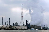 Chimneys and smoke from oil refinery in Antwerp harbour, Belgium