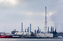 Chimneys and smoke from oil refinery in Antwerp harbour, Belgium