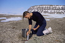 Producer Martha Holmes washing her hair in the Canadian Arctic, May 1998, on location for BBC NHU Blue Planet series
